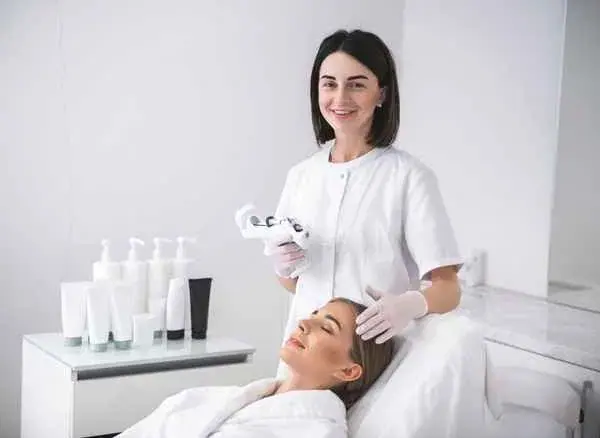 A professional therapist performing a skincare treatment, representing the high-end service a website should reflect.