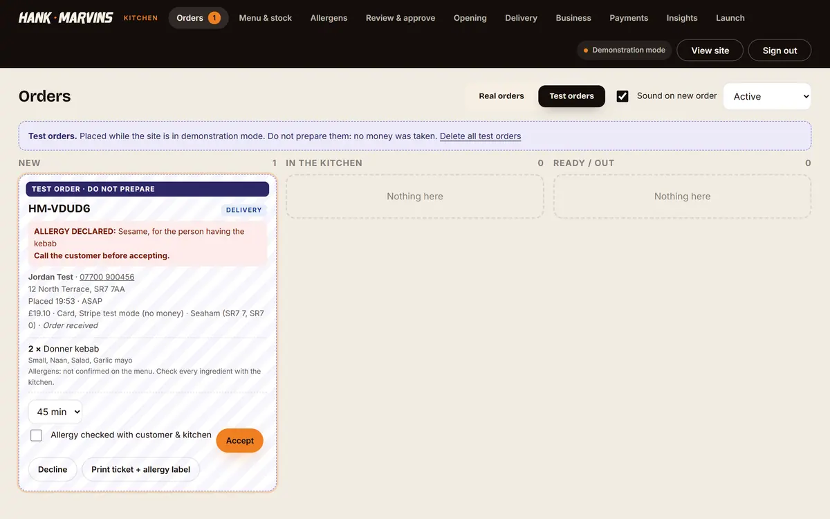 The Hank Marvins kitchen board with a test delivery order flagged for a sesame allergy, awaiting acceptance