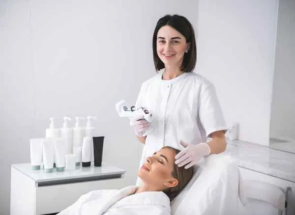 A professional therapist performing a skincare treatment, representing the high-end service a website should reflect.